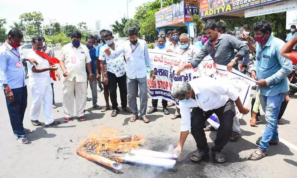 Trade union leaders burning an effigy of Prime Minister Narendra Modi in Visakhapatnam on Tuesday