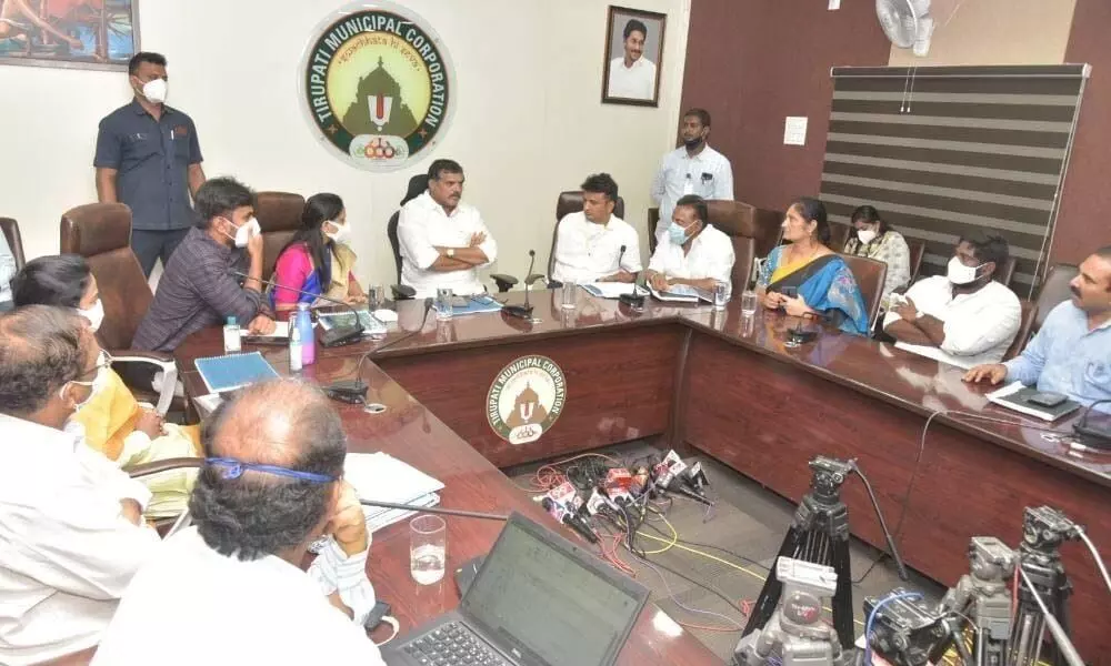Municipal Administration and Urban Development Minister Botcha Satyanarayana holding a meeting with officials at the municipal corporation office in Tirupati on Tuesday
