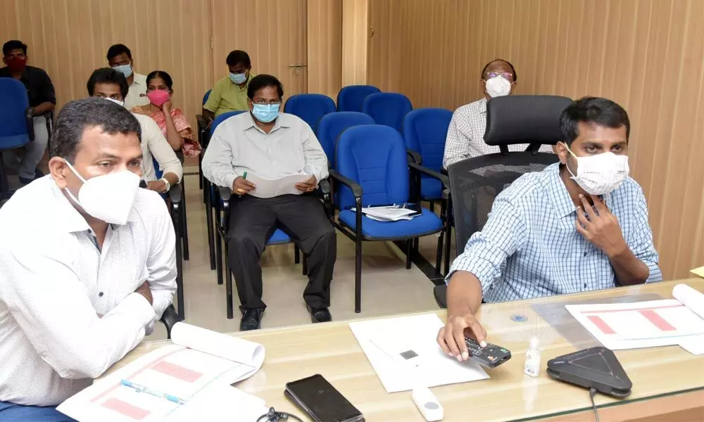 Collector M Hari Narayanan, Joint Collector V Veerabrahmam and others reviewing Covid situation through video conference from RDO office in Tirupati on Tuesday