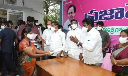 Telangana Minister Puvvada Ajay Kumar distributing CMRF cheques