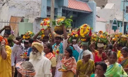 Women carrying Bonalu to offer them to Goddess Peddamma at Peapully in Kurnool district on Tuesday