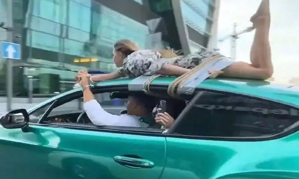 Girlfriend tied to car roof for trust test by a Russian Influencer