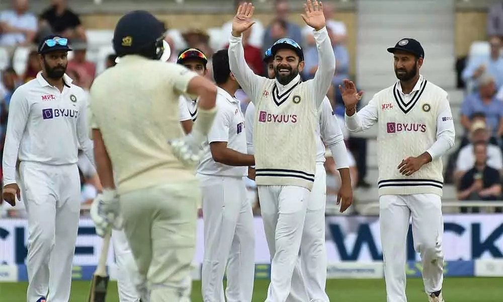 Indias captain Virat Kohli and teammates celebrate the dismissal of Englands Ollie Robinson during the first day of first test cricket match between England and India, at Trent Bridge in Nottingham on Wednesday