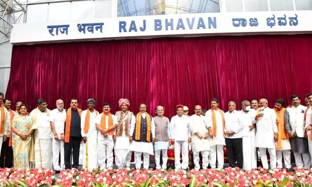 Chief Minister Basavaraj Bommai with newly inducted ministers during the swearing-in ceremony at Raj Bhavan in Bengaluru