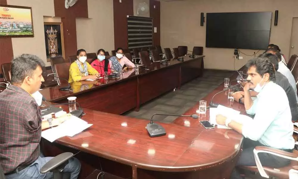 MCT Commissioner P S Girisha holding a review meeting with health department staff on Corona pandemic situation at municipal office in Tirupati on Thursday
