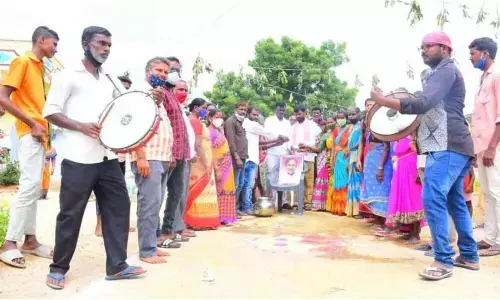 Dalith families performing palabhishekam to the portrait of CM K Chandrashekar Rao in Vasalamarri on Thursday