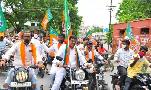 BJYM leaders conducting bike rally demanding job notifications in Khammam on Thursday