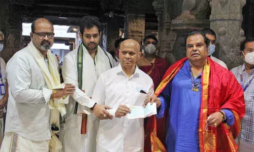 Hyderabad-based Rasoon Exports Private Limited Managing Director  K Ravinder Reddy handing over Rs 30 lakh cheque towards Sri Balaji Arogya Vara Prasadini Scheme to TTD Additional EO A V Dharma Reddy at Ranganayakula Mandapam in Tirumala on Thursday.