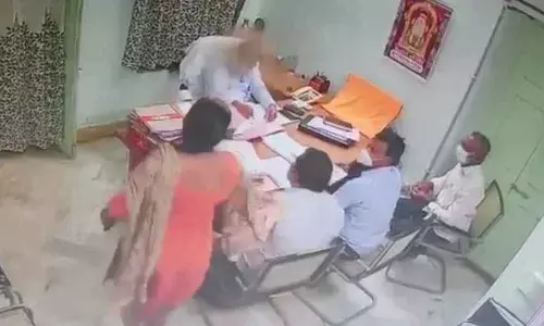 A video clipping of Assistant Commissioner of Endowments K Santhi throwing sand at Deputy Commissioner of the department EV Pushpavardhan at his chamber in Visakhapatnam