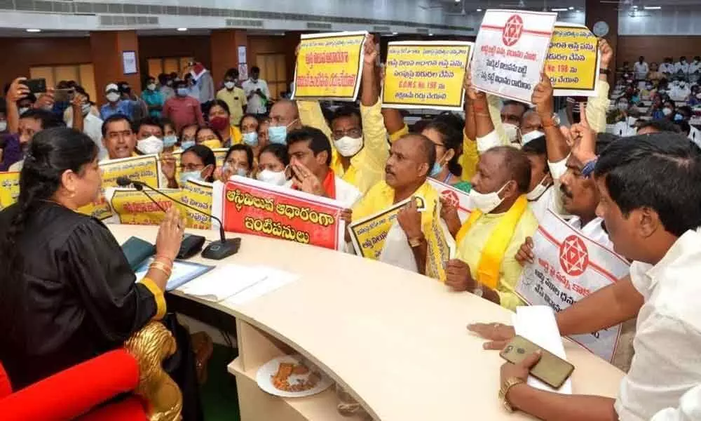 Opposition party corporators protesting at the council hall against the hike in property tax during the council meeting at GVMC in Visakhapatnam on Saturday