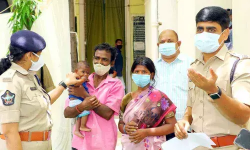 Urban SP Venkata Appala Naidu and Additional SP Supraja handing over the kidnapped boy to his parents at DPO in Tirupati on Saturday.