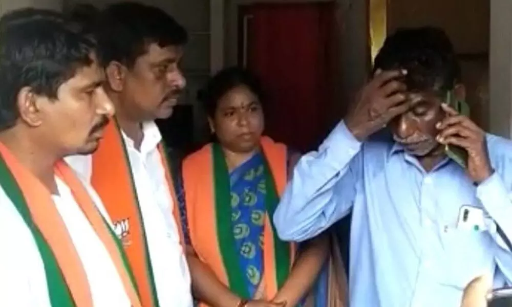 Victim’s father speaking to BJP State president Bandi Sanjay Kumar over phone, at Uppalamadaka village on Sunday
