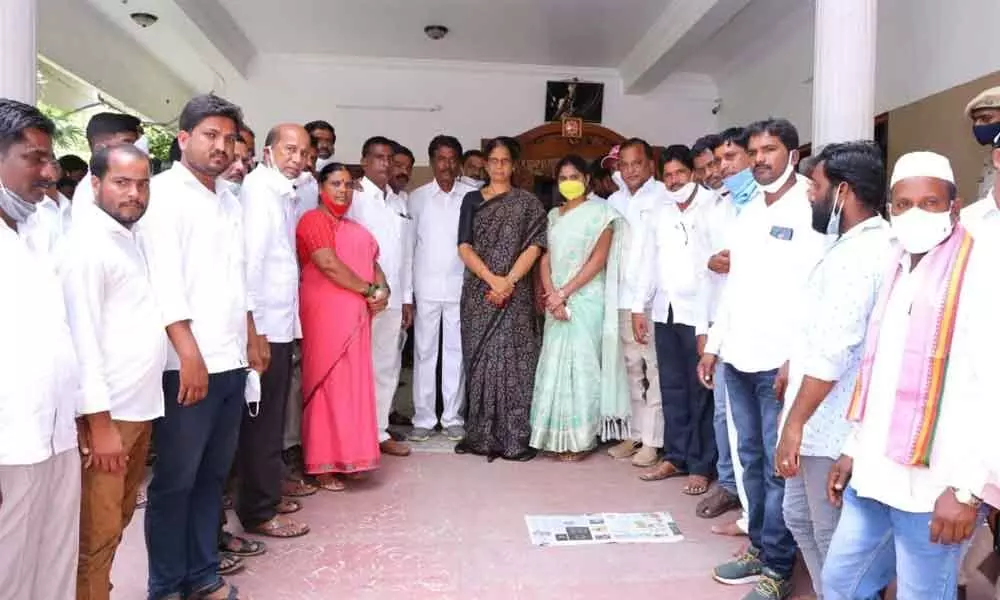 Education Minister Sabitha Indra Reddy along with tribals at her residence in Srinagar Colony on Sunday