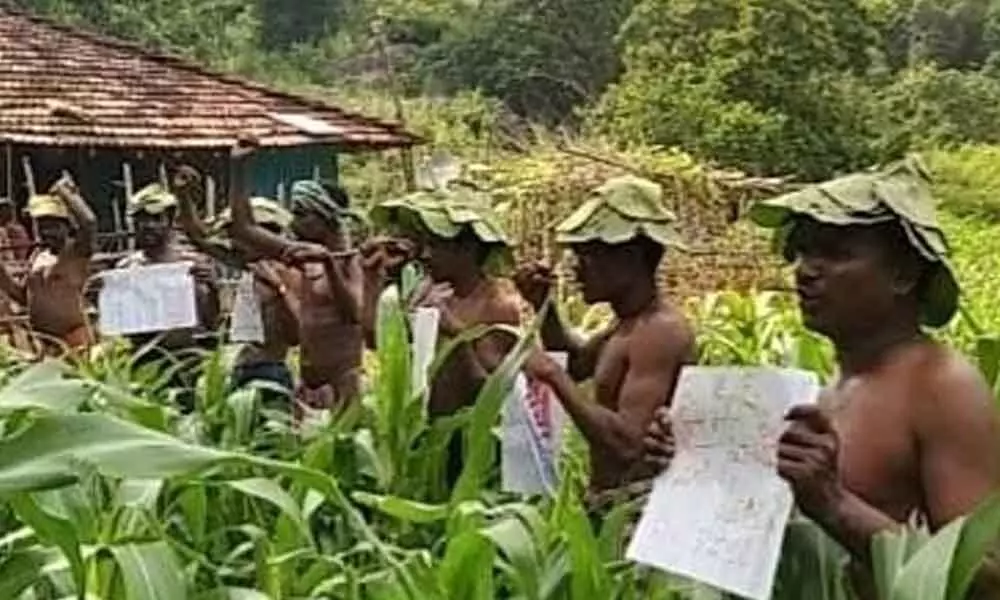Tribals staging a protest demanding minimum amenities in Agency areas in Visakhapatnamon Monday