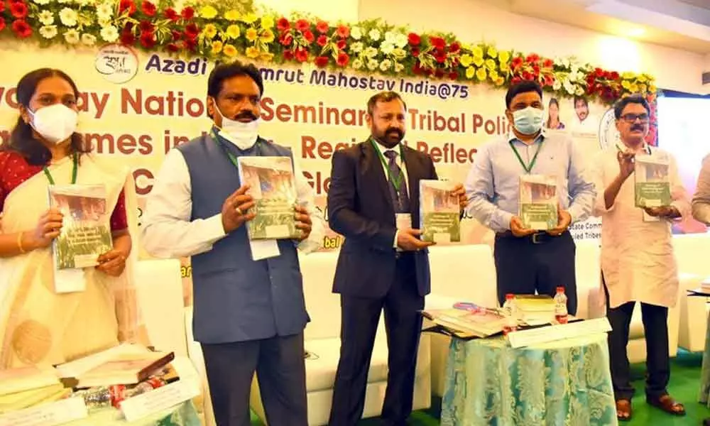 Tribal Welfare Secretary Kantilal Dande, Director P Ranjit Basha, Tribal Culture and Training Mission Director E Ravindra Babu and Deputy Director D Lakshmi  releasing a book on ‘Azadi ka Amrut Mahotsav, India @75’ during a national seminar on ‘Tribal Policies and Programmes in India-Regional Reflections in the Context of Globalisation’,  at a private hotel in Vijayawada on Monday