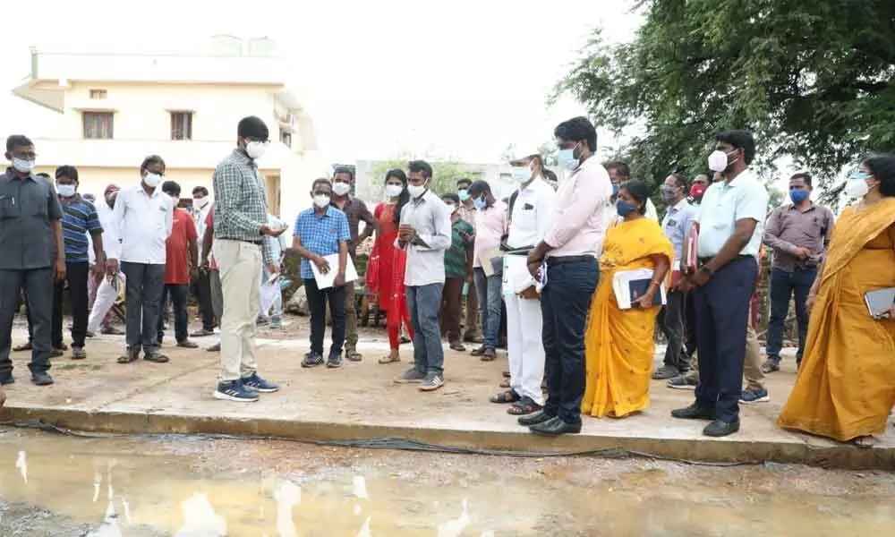 District Collector VP Gowtham along with officials observing stagnated water in Raghunadhapalem village on Tuesday