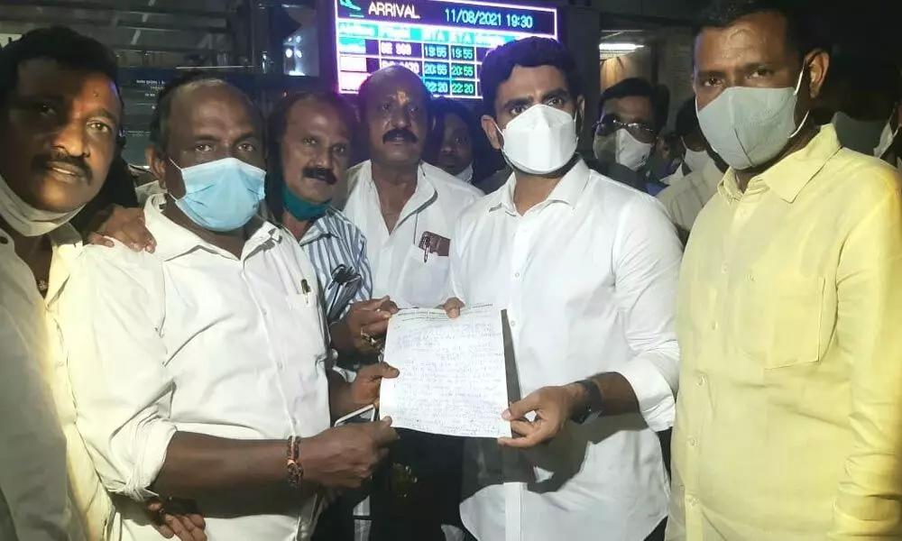 Displaced families and TDP leaders submitting a memorandum to TDP national general secretary Nara Lokesh at Visakhapatnam airport on Wednesday