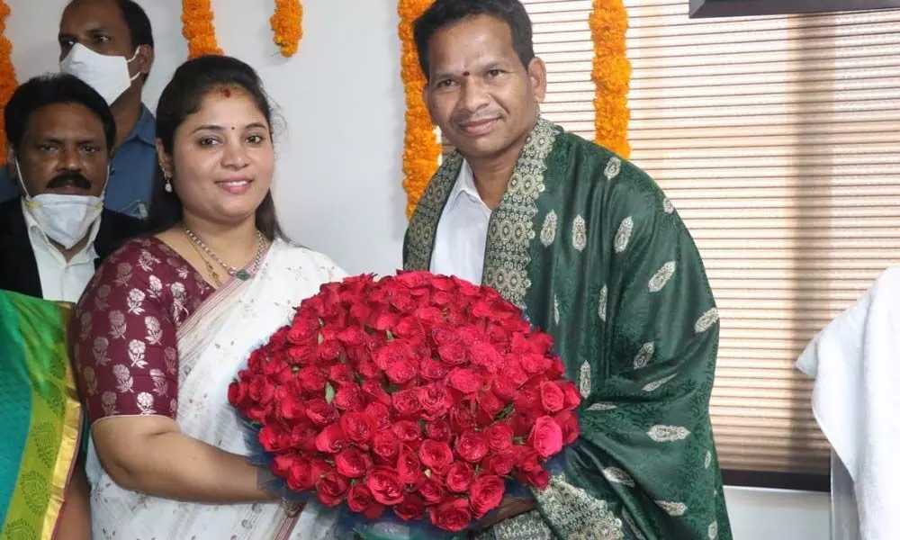 Deputy Chief Minister Pamula Pushpasrivani congratulating the new Chairman of TRICOR Sataka Bulli Babu in Vijayawada on Wednesday