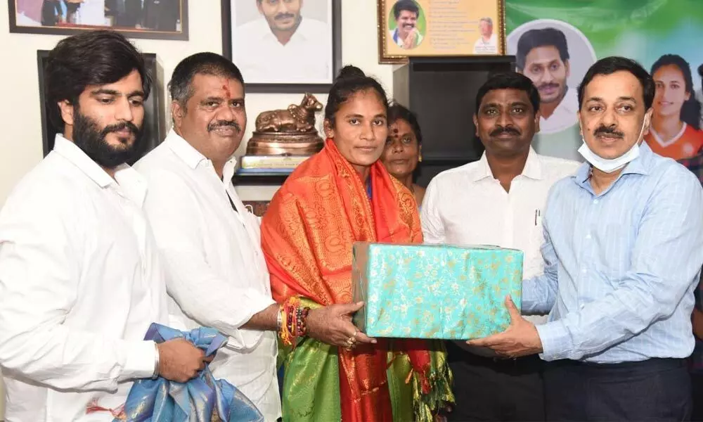 Minister for Tourism and Sports Muttamsetti Srinivasa Rao andSpecial Chief Secretary Rajat Bhargava felicitating Olympics hockey player Rajani in Amaravati on Wednesday