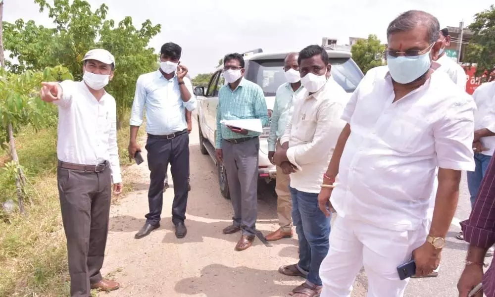 District Collector Prashanth Jeevan Patil inspecting saplings planted along on roadside in Yellareddy Gudem limits  on Thursday