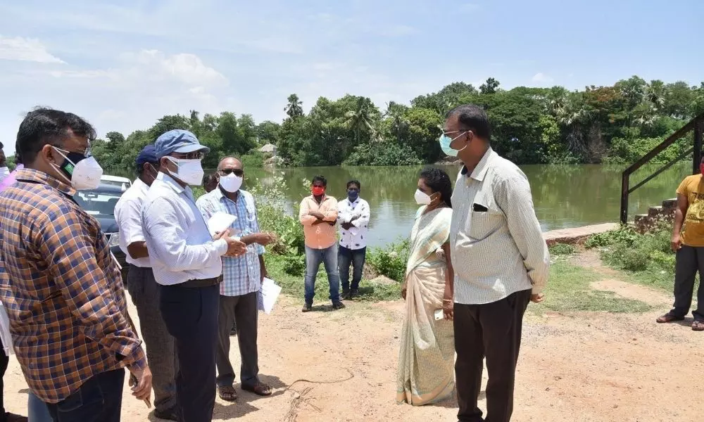 Collector inspects water flow in canal