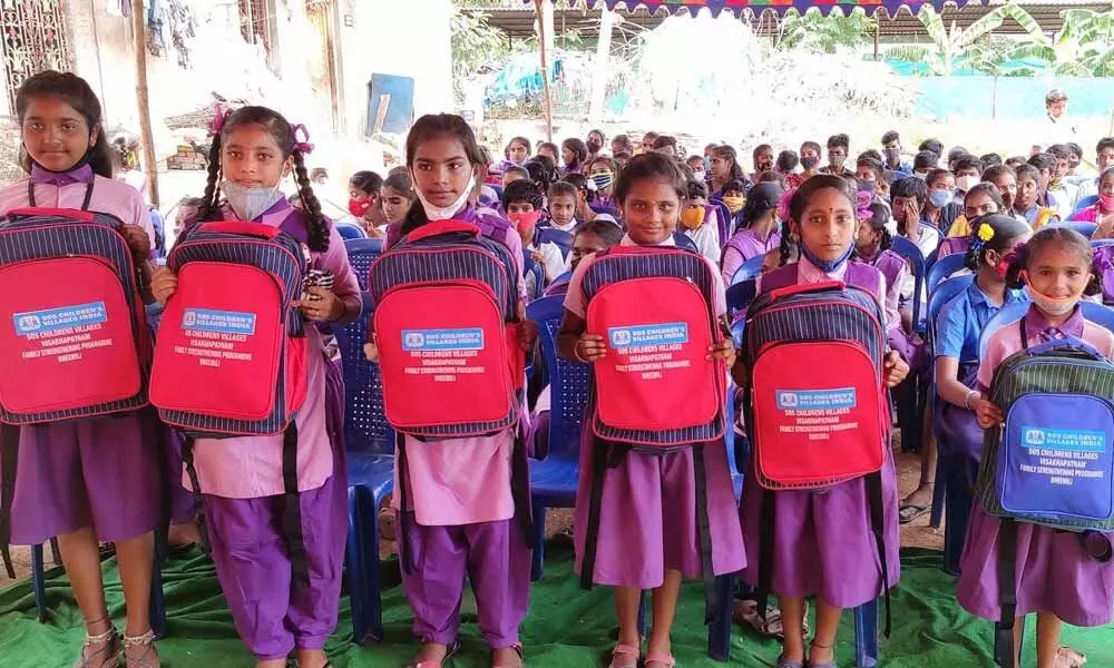Revidi High School students with the stationery sets distributed by SOS Children’s Village in Visakhapatnam on Friday