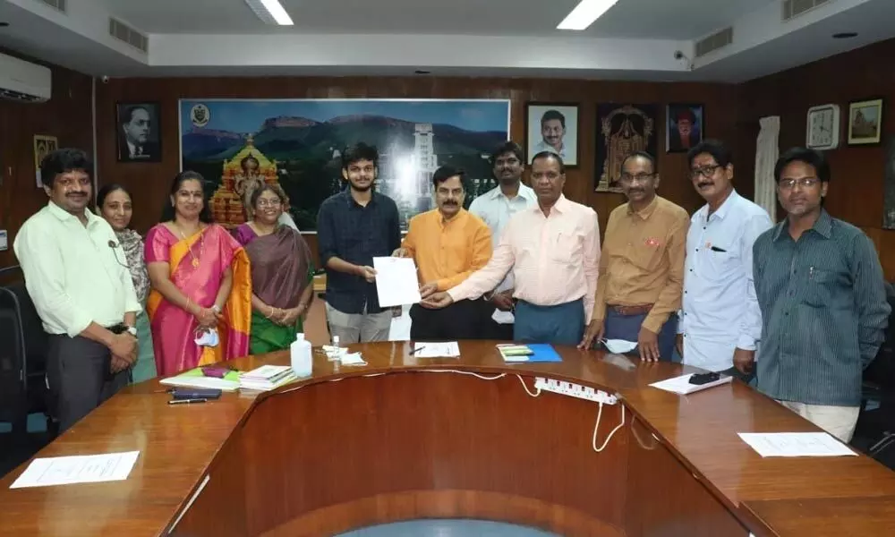SVU Vice-Chancellor Prof K Raja Reddy handing over the offer letter to an engineering student on Friday. Rector Prof GM Sundaravalli and others are seen