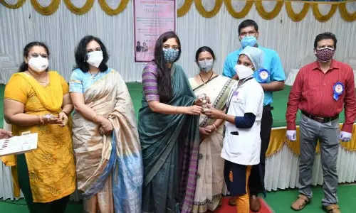ECoRWWO president Parijata Satpathy distributing mementos to the participants at the health check camp held in Visakhapatnam on Friday