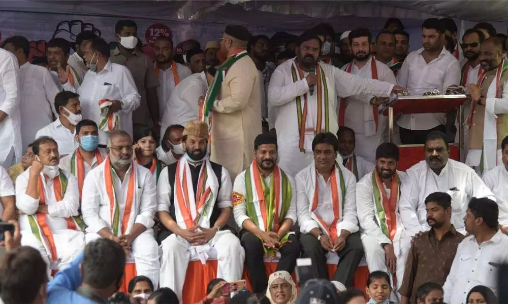 MP Uttam Kumar Reddy and TPCC chief A Revanth Reddy along with party members sit in a protest seeking Minority Bandhu, in Hyderabad on Saturday