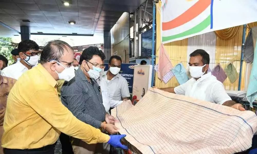 Waltair divisional railway manager Anup Kumar Satpathy browsing through the products at a stall put up at Visakhapatnam railway station on Saturday