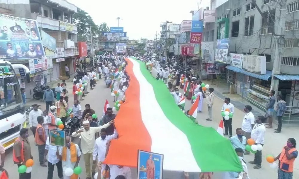 People taking part in a rally carrying a huge national flag on the occasion of the 75th Independence Day at Punganur in Chittoor district on Sunday