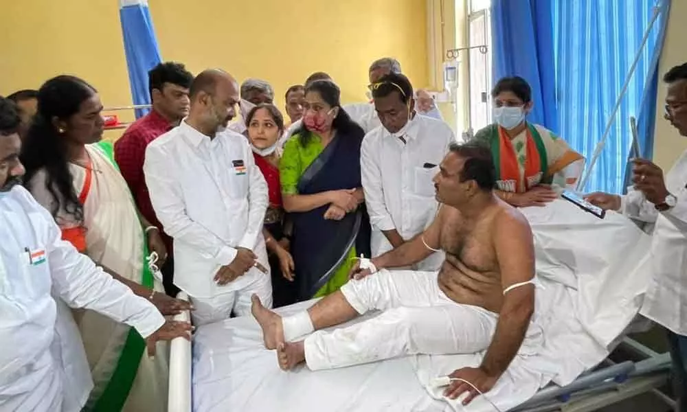State BJP president Bandi Sanjay and other BJP leaders call on an injured BJP corporator who was attacked by TRS workers, at a hospital on Sunday