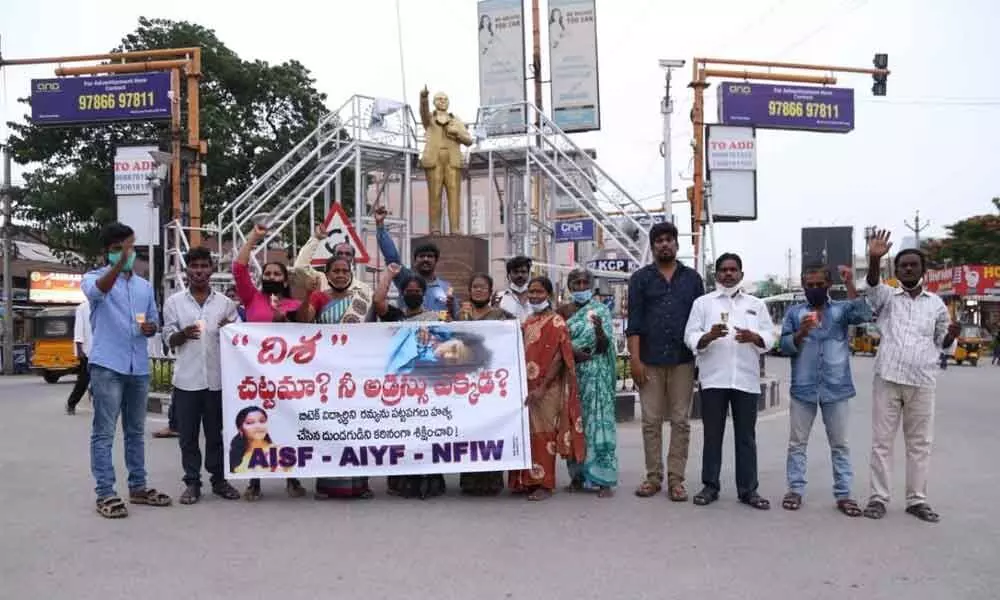 Leaders of APMS along with AIYF and AISF at Gandhi Statue near RTC bus stand in Tirupati after organising a candle rally  on Monday