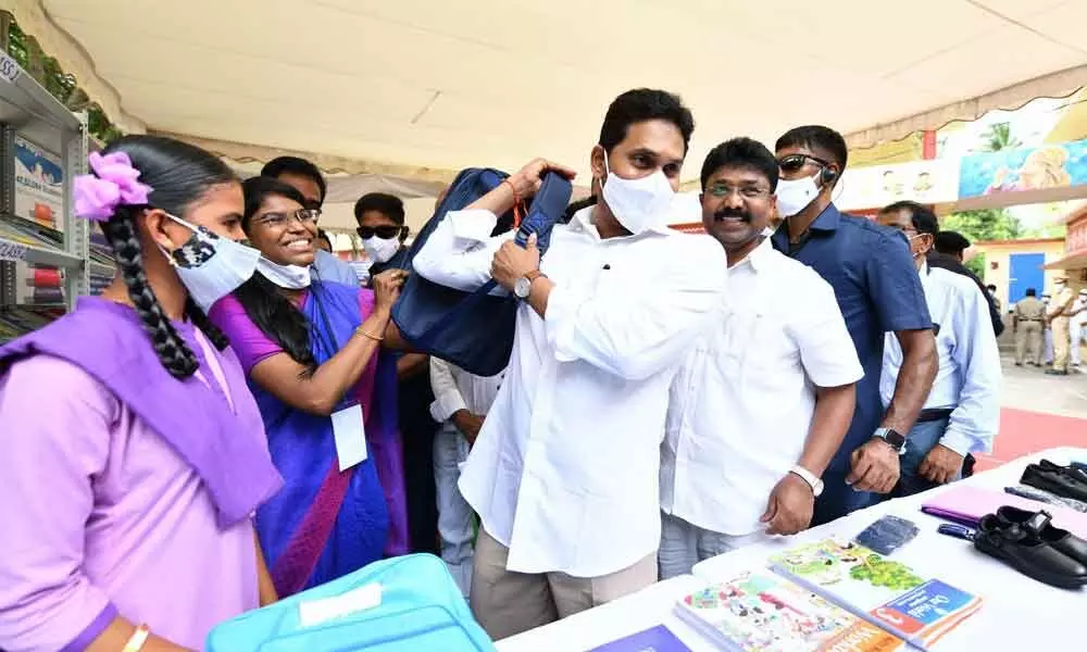 Chief Minister YS Jagan Mohan Reddy distributes Jagananna Vidya Kanuka kits to students during the launch of first phase of Mana Badi-Nadu Nedu programme at ZPP High School at P Gannavaram in East Godavari district on Monday