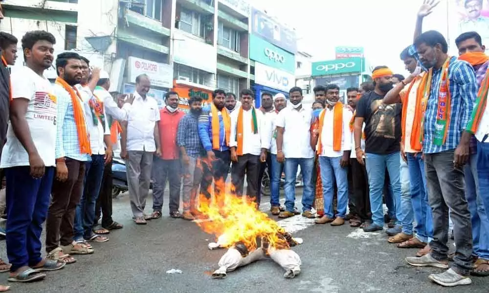 BJP leaders and activists burning the effigy of TRS MLA Mynampally Hanumantha Rao in Khammam on Monday