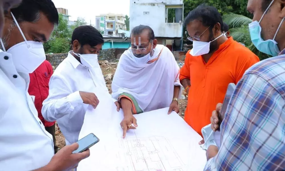 Energy Minister Jagadish Reddy, Yadadri temple sculptor Anand Sai and Stapathi Valliyanagan examining the revival plan of Lord Venkateshwara Swamy temple in Suryapet on Tuesday