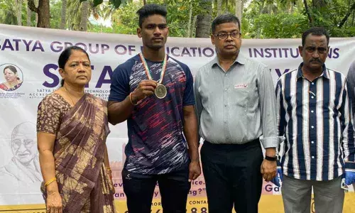 Dr.M.Sashibhusnana Rao and others congratulating the weight lifter Narasimha Naidu.