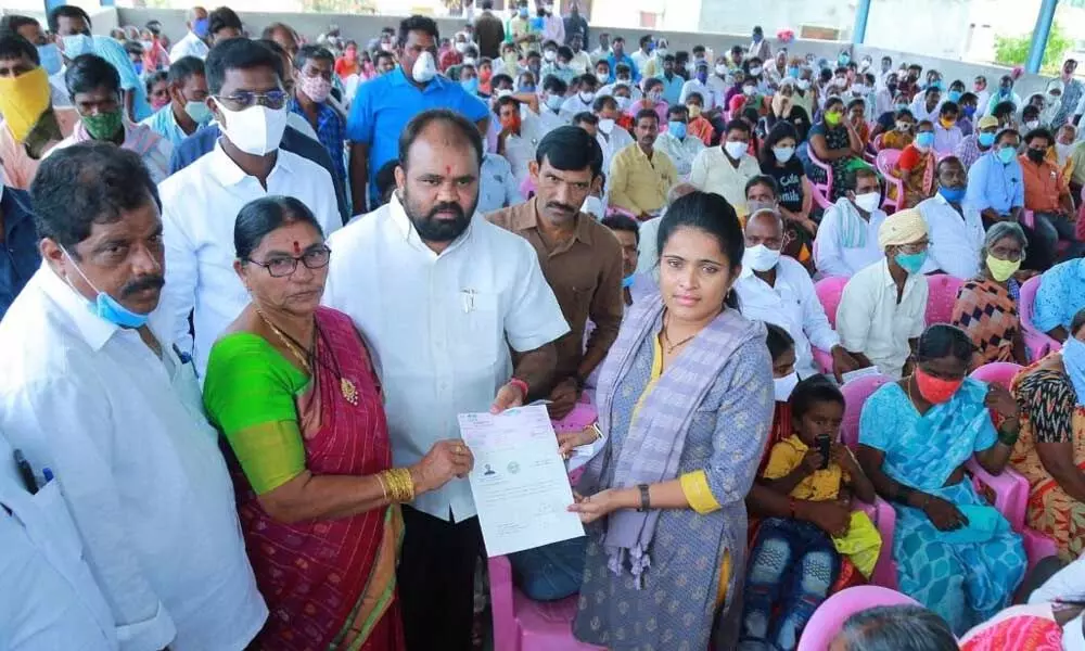 MLA Bhupal Reddy handing over CMRF cheque to a beneficiary at his camp office in Nalgonda on Wednesday