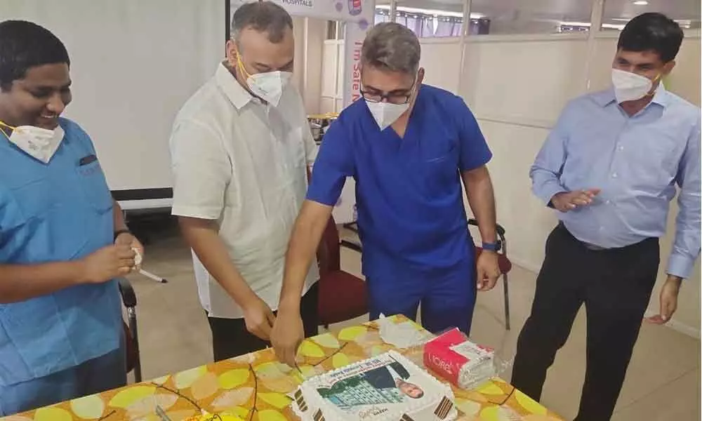 Dr Tirumala Reddy cutting a cake celebrating his birthday and marking the 10th anniversary of Sanghamitra Hospital in Ongole on Wednesday