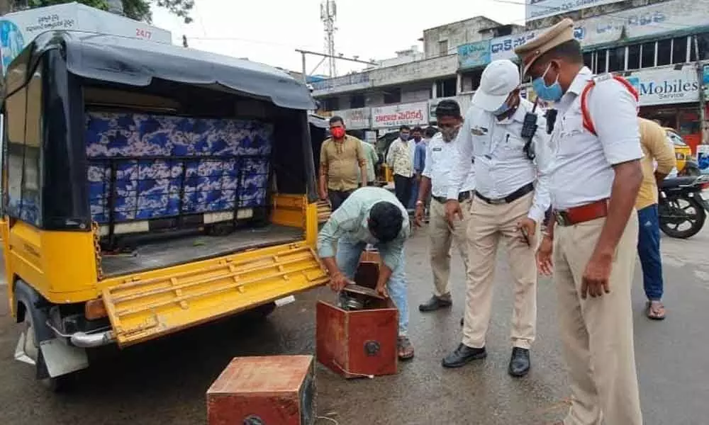 Traffic police removing speaker boxes from auto-rickshaws in Srikakulam on Friday