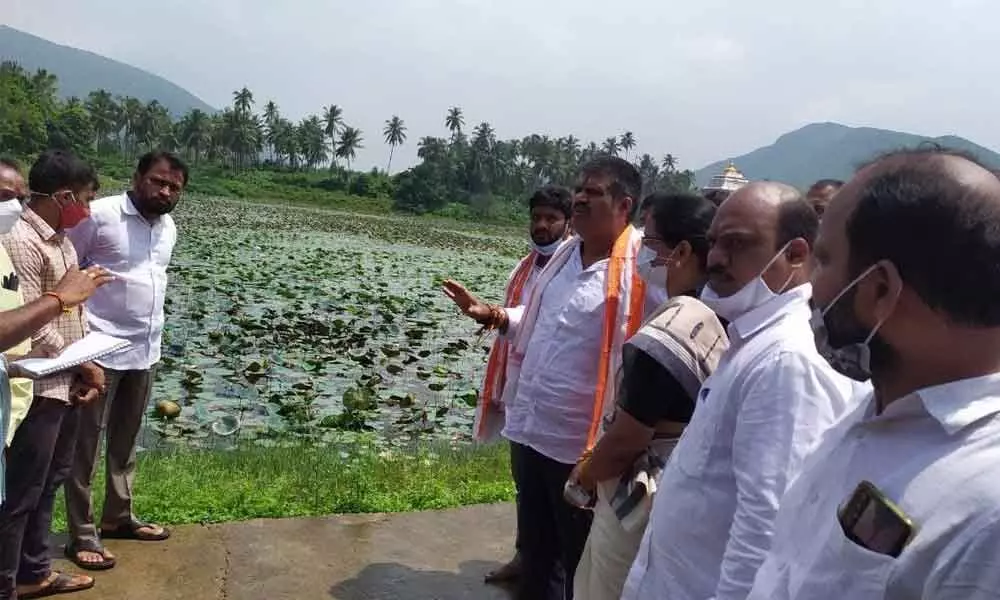 Tourism Minister M Srinivasa Rao inspecting the Varaha Pushkarini pond at Simhcahalam Devasthanam in Visakhapatnam on Saturday