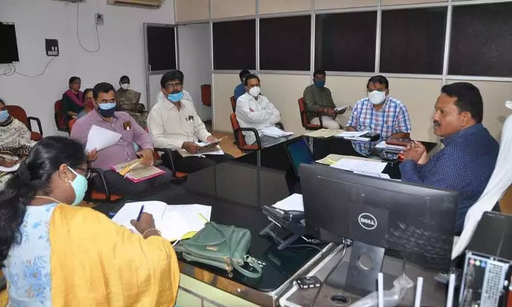 Joint Collector M V K Srinivasulu holds a review meeting with the officials on bank linkage loans to SGHs under Jagananna Cheyutha Scheme at his chambers in Kurnool on Saturday