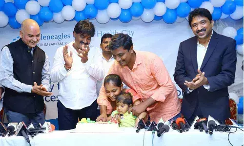 Srikalahasti MLA Biyyapu Madhusudhan Reddy, Global Hospital doctors and the parents of the boy cutting a cake at Srikalahasti on Saturday