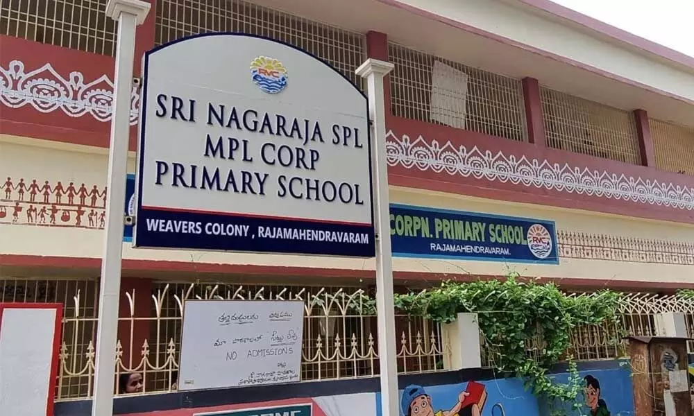 A renovated municipal primary school displaying ‘No seats’ board in Rajamahendravaram