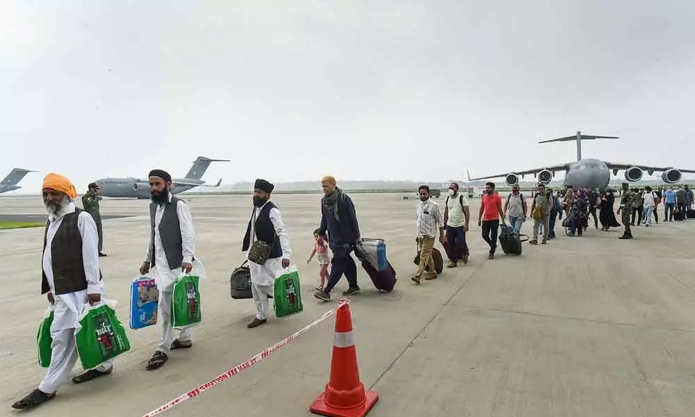 People who were stranded in crisis-hit Afghanistan arrive by a special repatriation flight of IAF at the Hindan Air Force Station, in Ghaziabad on Sunday