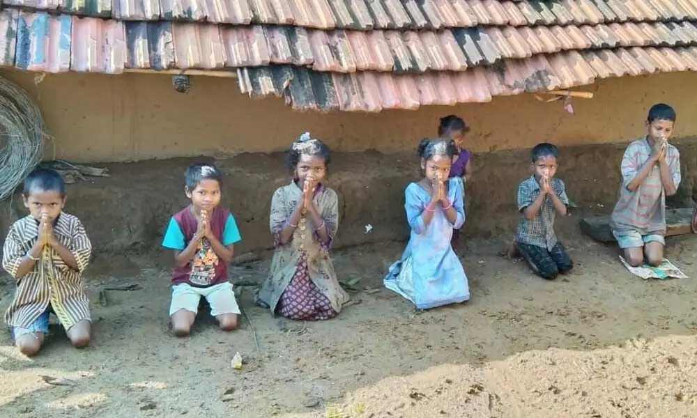 Children of Neredubanda of Ravikamatham mandal staging a protest, demanding Aadhaar cards for them in Visakhapatnam on Sunday