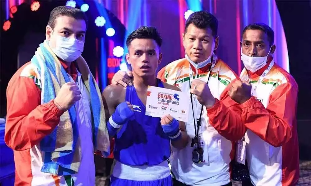 Bishwamitra Chongtham (51kg) celebrates with the coaches after winning his quarter final bout at the ASBC Youth & Junior Boxing Championships in Dubai on Sunday