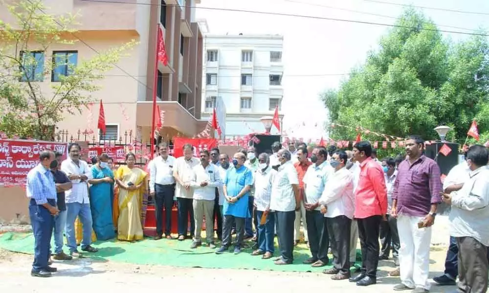 LIC staff attending the LIC Employees Union flag hoisting programme at their office in Bhavanipuram, Vijayawada on Tuesday