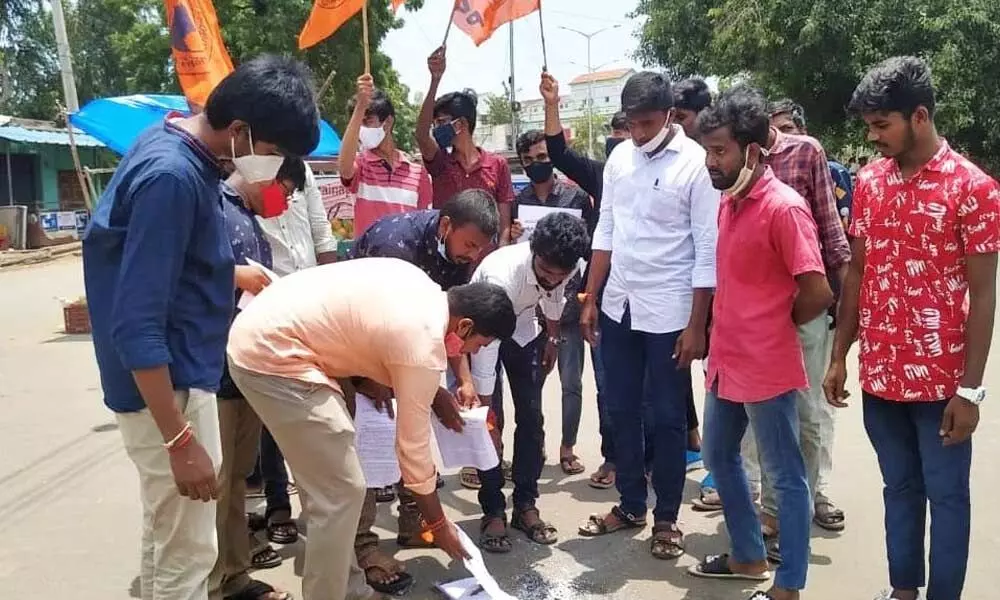 ABVP activists burning copies of the GO 42 at Muthukur Gate Centre on Wednesday