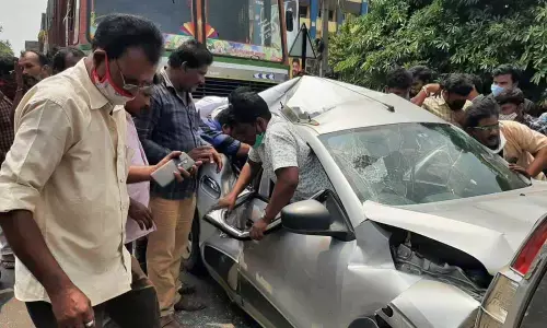 Locals pulling out trapped persons from the car in Visakhapatnam on Wednesday